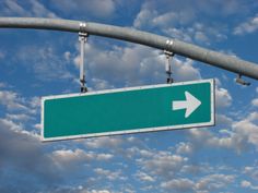 a green street sign with an arrow pointing to the right under a cloudy blue sky