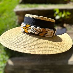 Our Mexican, high quality Artisal Palm Hat, comes with a removable hand embroidered band.  The band is embroidered by Female Artisans of the Andes in Perú.  This classic wide brim hat has sturdy weave to be used in the beach and all adventures in the sun.  Great sun protection.  The close-weave material in this product offers UPF 50+ which blocks 97.50% of the sun's UV rays. Hat Brim measures 4 3/4" wide Crown of hat measures 3 3/4" tall One size Adjustable Handwoven Boater Hat With Flat Brim, Handwoven Adjustable Boater Hat With Flat Brim, Handwoven Adjustable Wide Brim Boater Hat, Adjustable Flat Brim Boater Hat For Garden Party, Bohemian Visor Straw Hat For Vacation, Bohemian Beach Visor Hat, Bohemian Visor Straw Hat For Spring, Spring Bohemian Visor Straw Hat, Adjustable Cream Woven Panama Hat