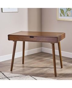 a wooden desk with drawers on it in front of a white carpeted floor and beige walls