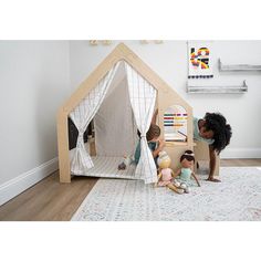 children playing with their toys in a play house made out of wood and canvass