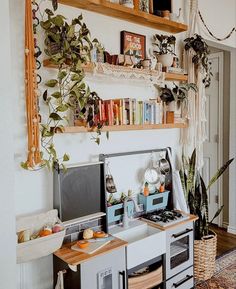 a kitchen area with an oven, microwave and bookshelf