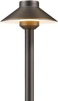 a lamp that is sitting on top of a metal pole with a white light in the middle