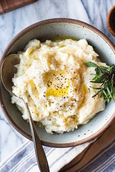 a bowl filled with mashed potatoes on top of a table