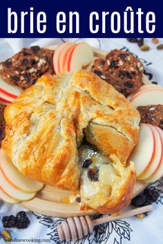 an apple and cheese pastry on a plate with the words brie en croute