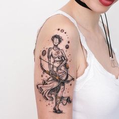 a woman with a bow and arrow tattoo on her arm