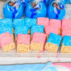 blue and pink rice krispy treats are on display