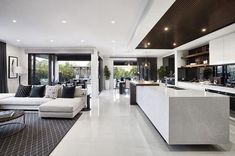 a living room filled with furniture and lots of windows