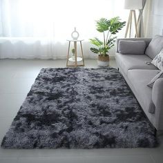 a living room with a gray couch and rug