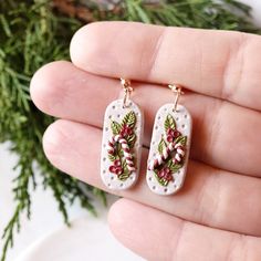 a pair of earrings with candy canes on them