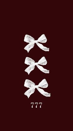 three white bows on a black background