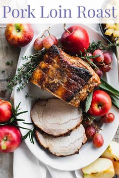 pork loin roast on a plate with apples and herbs