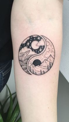 a black and white tattoo on the arm of a person with a yin - yang symbol