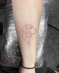 a woman's arm with a dog tattoo on it