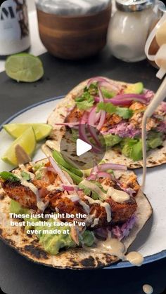 two flatbreads with meat, onions and lettuce are on a plate