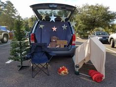 a teddy bear sitting in the back of a van