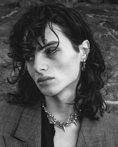 black and white photograph of a woman wearing a suit with spikes on her collar necklace