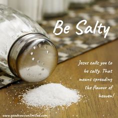 a salt shaker sitting on top of a wooden table next to a pile of salt