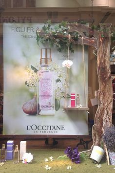 an advertisement for l'occitane perfume on display in a store window