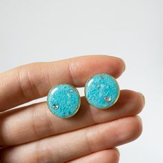 Round stud earrings with crushed turquoise inside, Swarovski crystals and pigments. Every crystal is made by hand and always slightly different one from another. 15mm round, surgical steel post and back. Turquoise Glass Round Jewelry, Turquoise Round Hallmarked Earrings, Turquoise Glass Round Bead Earrings, Blue Crystal Round Earrings For Gift, Blue Round Crystal Earrings In Metal, Crystal Frame, Steel Post, Round Stud Earrings, Sensitive Ears