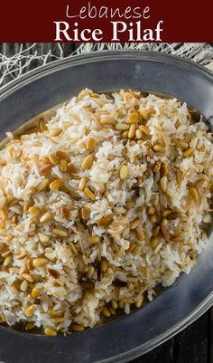 a bowl filled with rice and nuts on top of a table