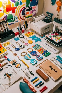 the table is covered with art supplies and crafts