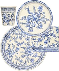 three blue and white plates, one with flowers on the plate and one with a cup