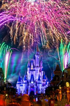 the castle is lit up with colorful fireworks