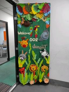 a green door decorated with jungle animals and plants