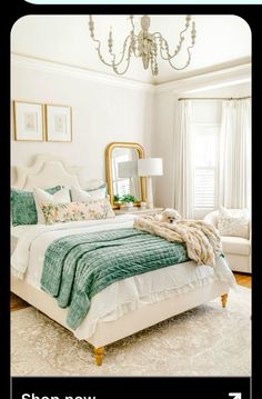 a bedroom with a bed, chandelier and pictures on the wall above it