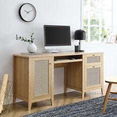 a wooden desk with a computer on top of it