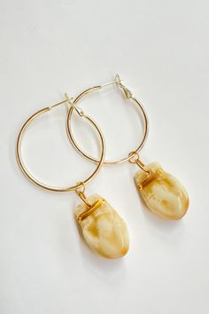 Who doesn’t love hoops? We’ve created our own take with a cherished ancestral style element, the elk tooth. For us, the elk tooth is a symbol of devotion and prosperity. We’ve designed these contemporary accessories to be worn by people from all walks of life. Elk teeth are often worn and utilized for traditional adornment by many Native American tribes from the Northern Plains.Our Jewelry is made to order and assembled in the Northern Cheyenne Nation.Details: Ivory Elk ivory Replicas Hand paint Elk Tooth Jewelry, Elk Teeth Jewelry, Elk Ivory Earrings, Nickel-free Cream Dangle Jewelry, Elk Ivory Necklace, Elk Ivory Jewelry, Indigenous Jewelry, Elk Ivory, Tooth Jewelry