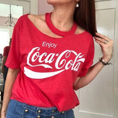 a woman wearing a red coca cola shirt