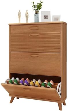 a wooden dresser with drawers filled with shoes and vases on top of it's shelf