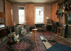 a living room with guitars and musical equipment