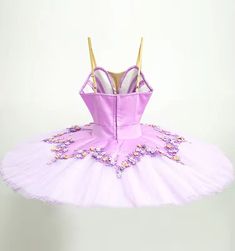 Professional pancake tutu designed for roles such as The Lilac Fairy. Satin lilac bodice with V neck and nude insert. Rich decoration with lilac and pink flower appliques, and rhinestones. Ten layers professional, white tutu skirt with flower shaped lilac tutu skirt, with decorations matching the bodice. Custom made. Delivery time: 6 to 8 weeks $ 630 Fitted Tulle Tutu Dress With Floral Applique, Fitted Lavender Tulle Tutu Dress, Lavender Princess Style Tutu Dress, Purple Fairy Style Tutu Dress, Fitted Lavender Princess Tutu Dress, Fitted Princess Style Lavender Tutu Dress, White Tutu Skirt, Lilac Fairy, Pancake Tutu