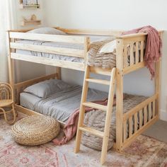 a wooden bunk bed sitting on top of a rug