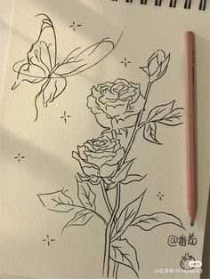 a drawing of two roses and a butterfly on a piece of paper with a pencil