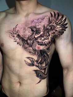 a man's chest with a bird tattoo on it