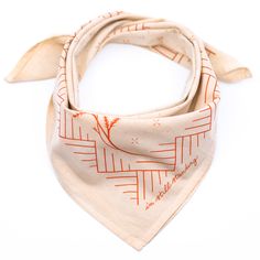 an orange and white bandana on top of a white surface with the words love written across it