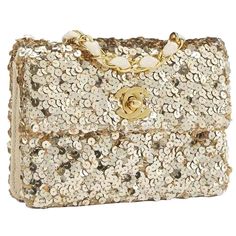 Chanel Classic Flap Rare Micro Mini Vintage Gold Sequin & Microfiber Bag1990 {VINTAGE 31 Years}Gold hardwareClassic interwoven chainCC turn-lock closureGold sequins throughoutMicrofiber interior lining5.5" W x 4" H x 1.5" DStrap Drop: 21.5"Made in FranceSimilar style seen on vintage ad and Khloe Kardashian. Luxury Sequined Rectangular Evening Bag, Luxury Gold Sequin Bag, Micro Mini Bag, Chanel Handbags Classic, Navy Blue Bag, Chanel Brand, Vintage Chanel Handbags, Classic Flap Bag, Mini Studs