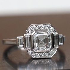 an old cut diamond ring with baguets on the sides