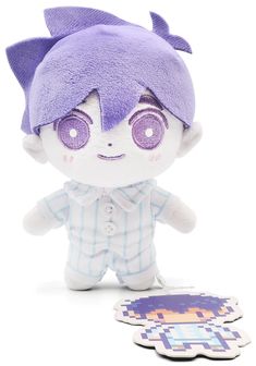 a stuffed animal with purple eyes sitting next to a sticker