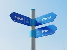 two blue street signs pointing in opposite directions against a clear blue sky with the words airport, capital and bank written on them