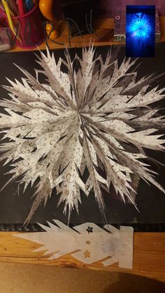 a paper snowflake sitting on top of a wooden table