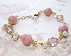 Beautiful Peruvian pink opals are accented with blush hued Swarovski crystals. Small white freshwater pearls dangle and make this bracelet unique and fun. A stunning gift for a woman born in October since the opal is her birthstone. A subtle natural pink gemstone jewelry, artisan and elegant, perfect for weddings and dressy occasions. Bracelet Details: - Pink opal gemstones are 9 mm. Pearls are 3 - 4 mm. - Bracelet length is 7.5 inches long (19.05 cm) plus a 1 inch extender - Handmade with 14k g Opal Bracelet Gold, Birthday Stone, October Birthstone Jewelry, October Birthday, Swarovski Crystal Bracelet, Wedding Jewelry Bracelets, Pink Jewelry, Opal Bracelet, White Freshwater Pearl