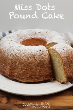 a pound cake on a white plate with the words miss dots pound cake cut in half