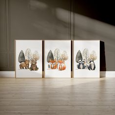 three framed pictures with animals on them sitting in front of a wooden floor and wall