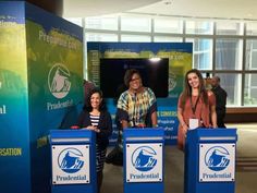 three women standing behind two blue podiums in front of a sign that says presidential