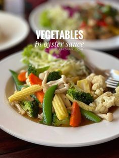 vegetables in oyster sauce on a white plate