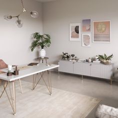 a living room filled with furniture and plants on top of a white table next to a couch